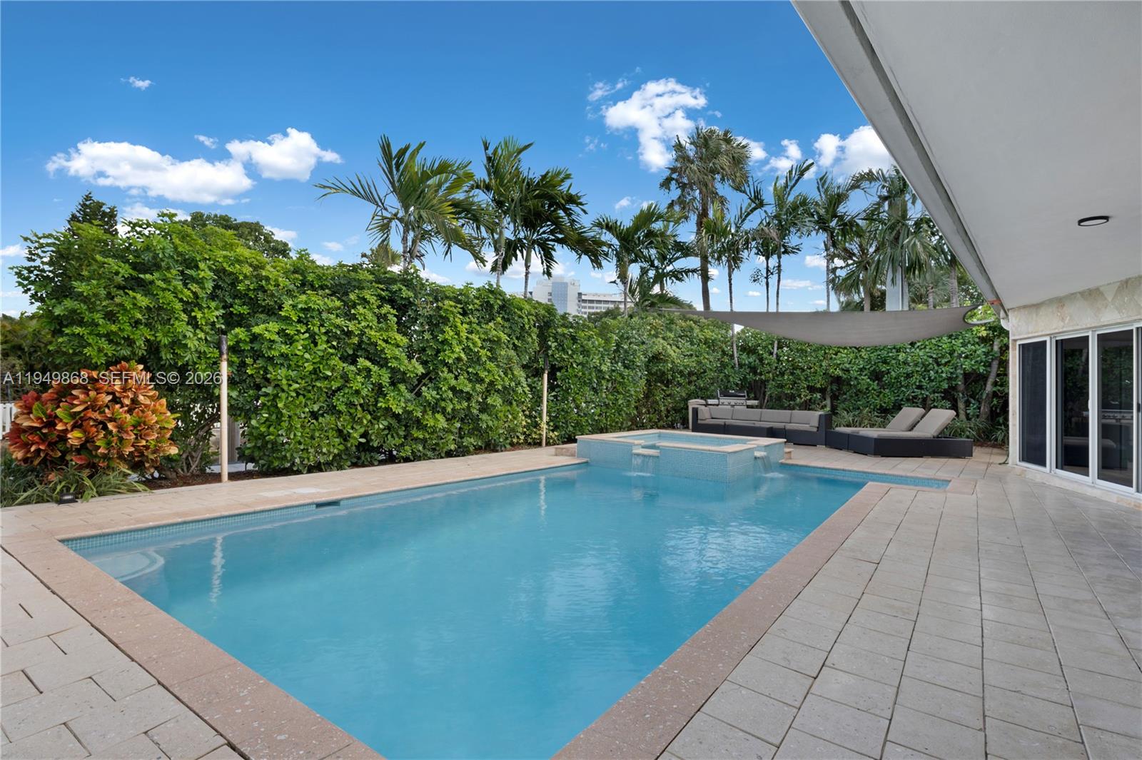 1155 South Biscayne Point Road Miami Beach, FL 33141 - Photo 3 of 23 a view of a swimming pool with a patio