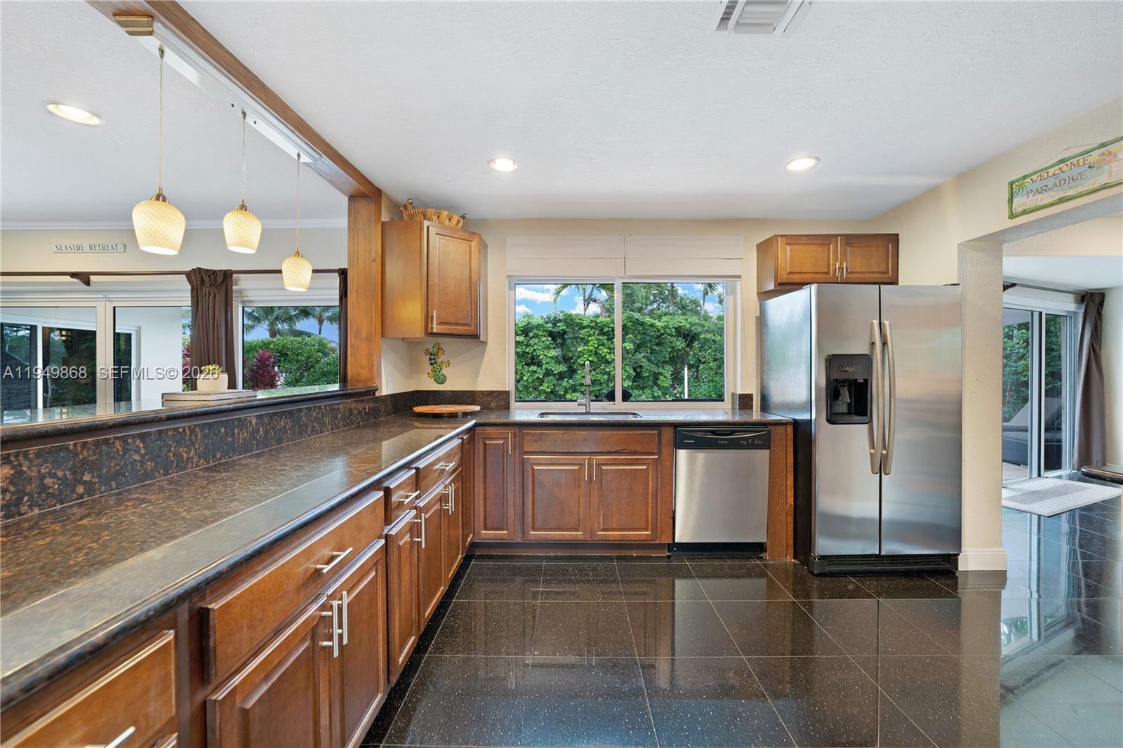 1155 South Biscayne Point Road Miami Beach, FL 33141 - Photo 10 of 23 a kitchen with stainless steel appliances granite countertop a refrigerator and a sink