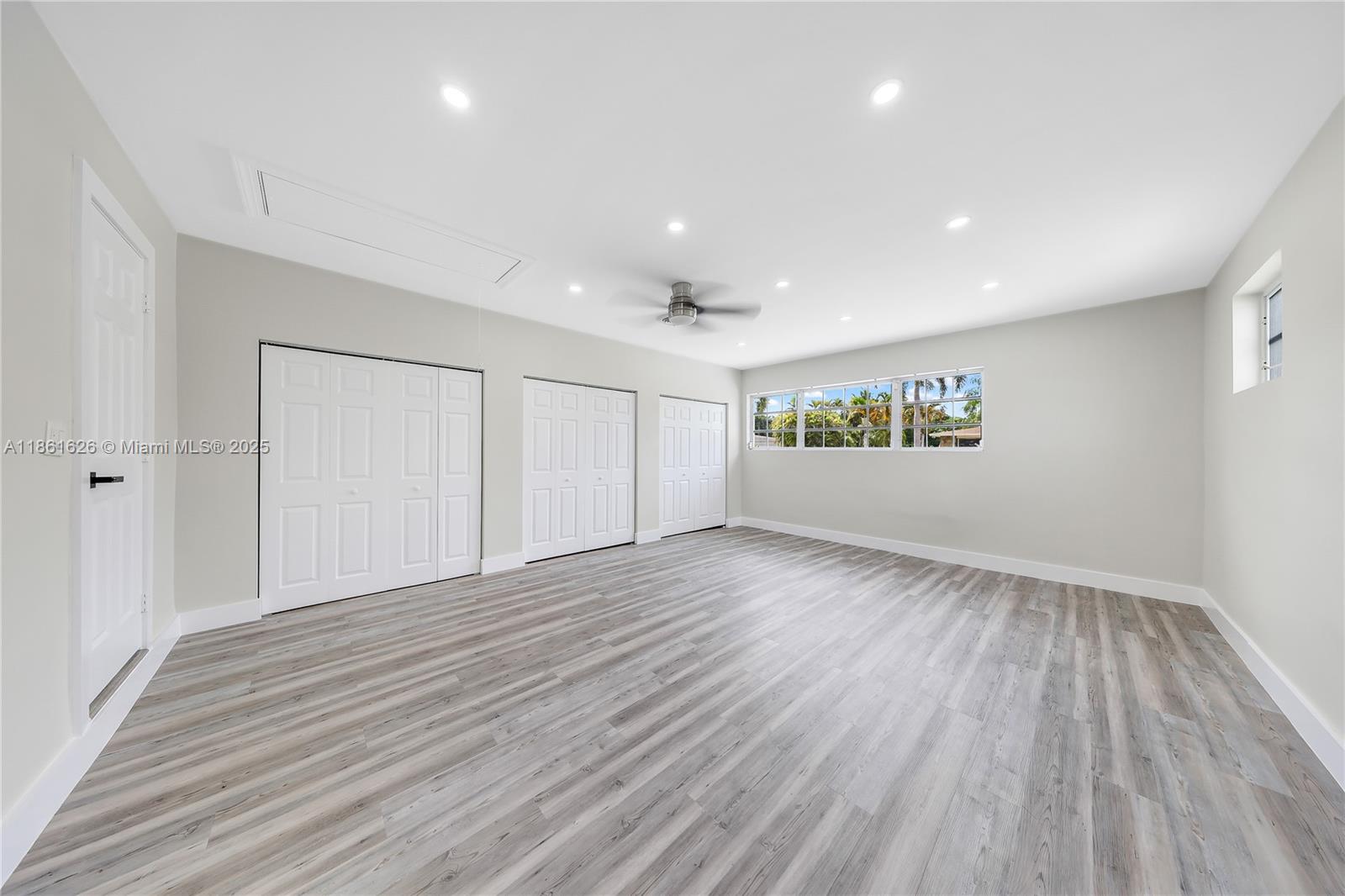 8355 Southwest 89th Street Miami, FL 33156 - Photo 11 of 29 a view of an empty room with wooden floor and a window