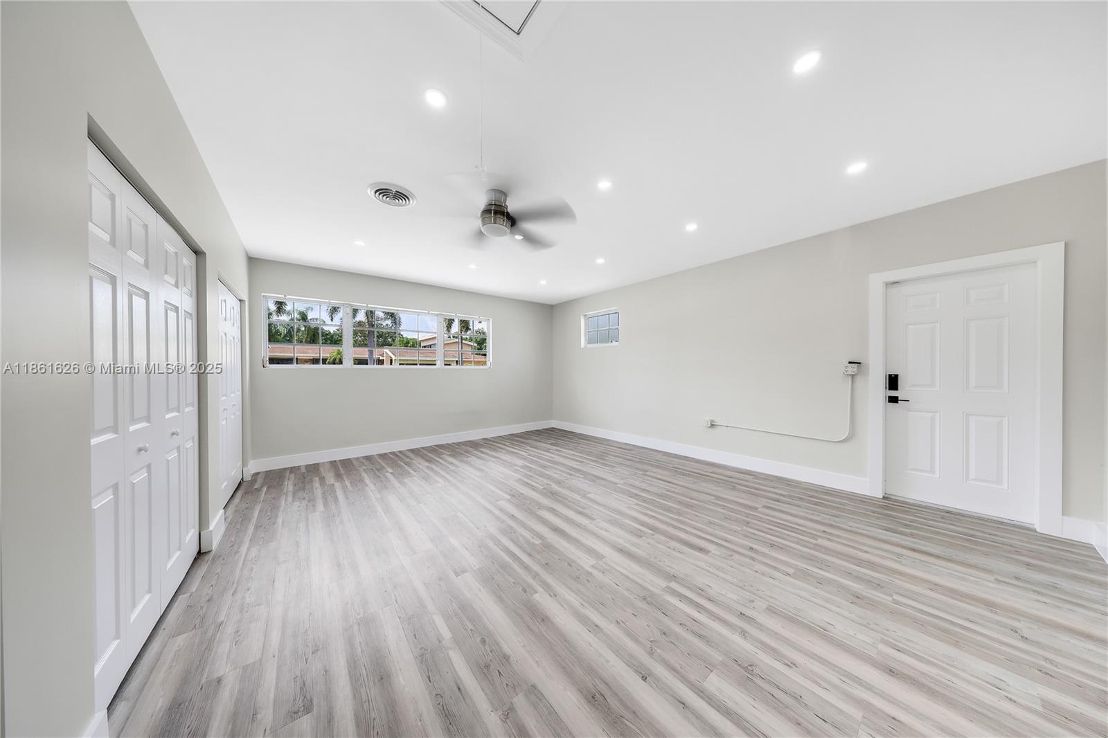 8355 Southwest 89th Street Miami, FL 33156 - Photo 12 of 29 an empty room with wooden floor and windows