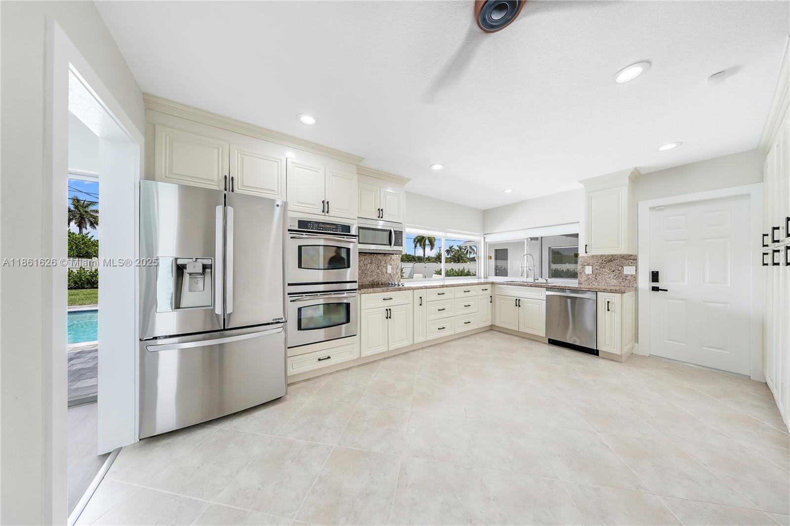 8355 Southwest 89th Street Miami, FL 33156 - Photo 13 of 29 a kitchen with stainless steel appliances a refrigerator sink and cabinets