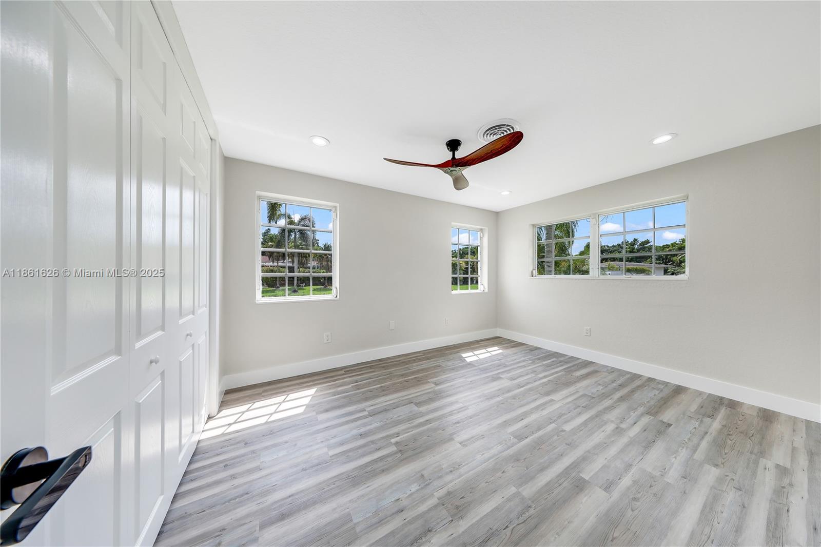 8355 Southwest 89th Street Miami, FL 33156 - Photo 17 of 29 a view of an empty room with wooden floor and a window