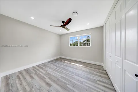 a view of a livingroom with wooden floor and window
