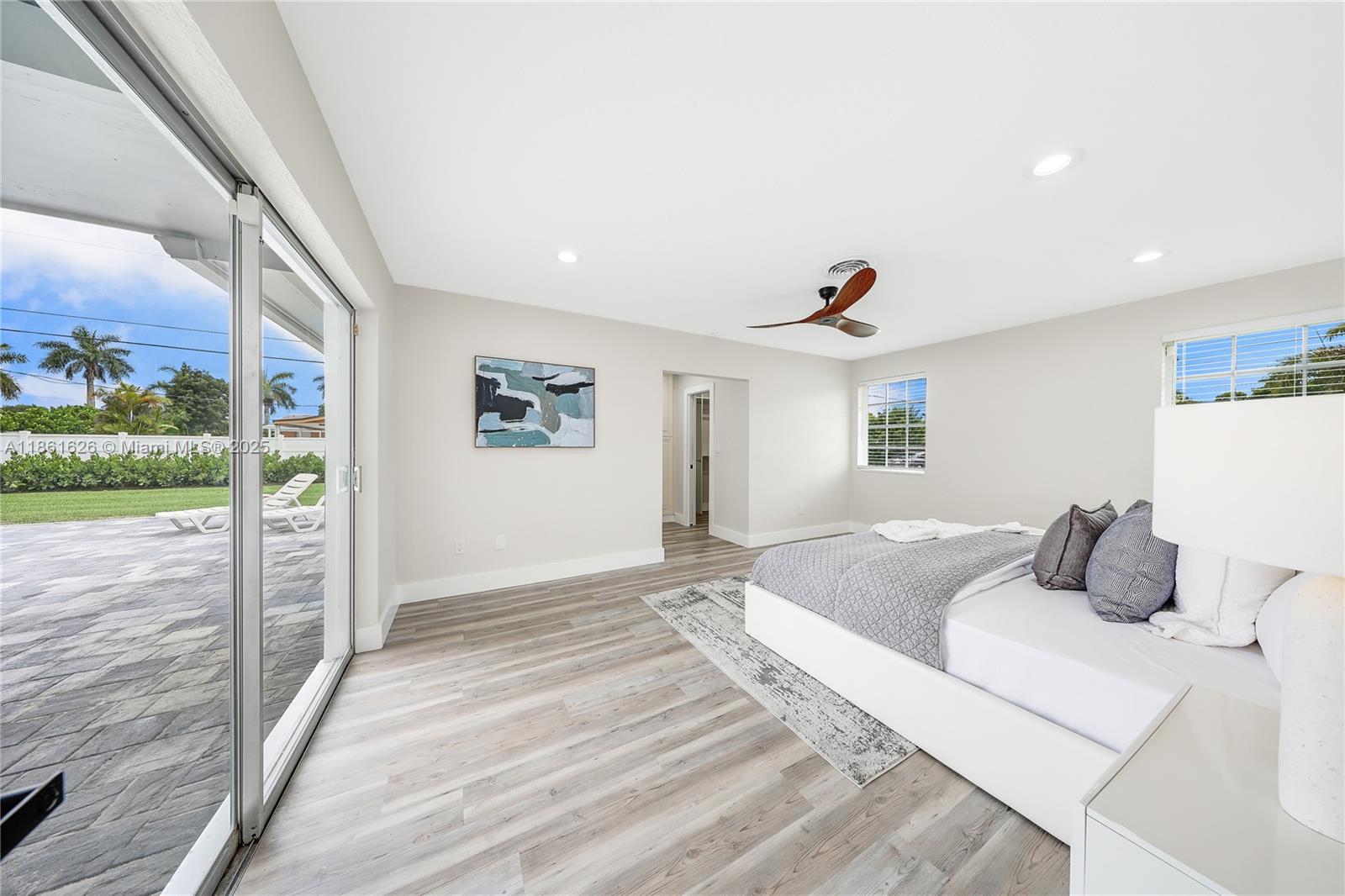 8355 Southwest 89th Street Miami, FL 33156 - Photo 19 of 29 a bedroom with a bed and a large window with balcony view