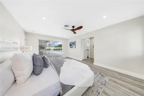 a bed room with bed and ceiling fan