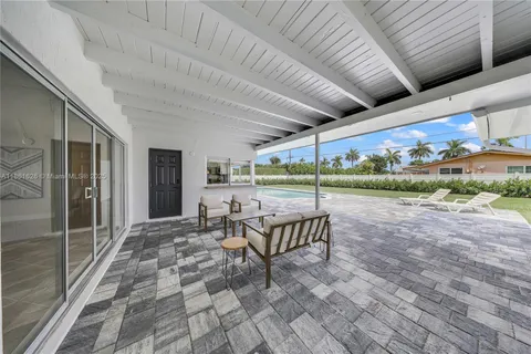 a view of a patio with a table and chairs