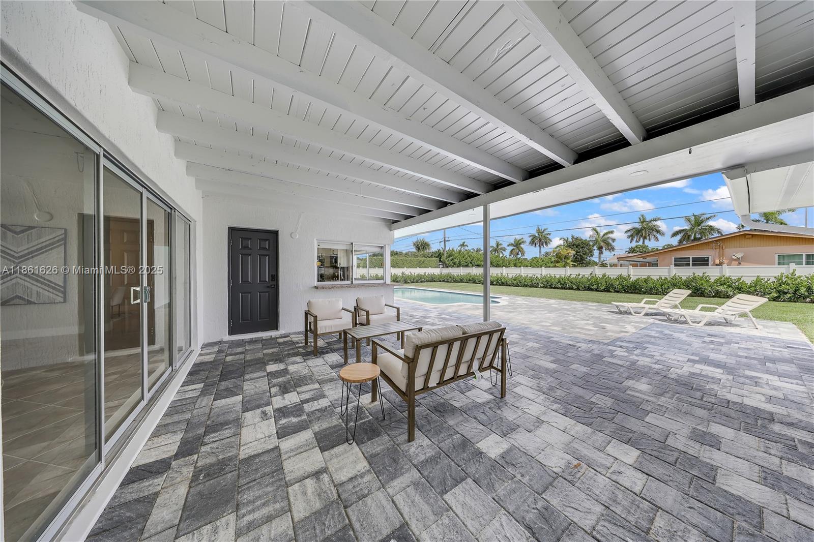 8355 Southwest 89th Street Miami, FL 33156 - Photo 22 of 29 a view of a patio with a table and chairs