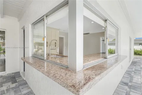 a view of a large room with wooden floor and a balcony