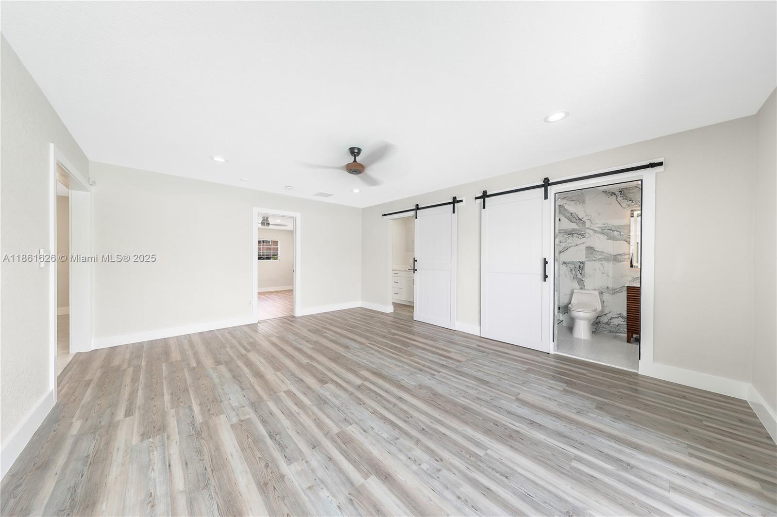 8355 Southwest 89th Street Miami, FL 33156 - Photo 8 of 29 a view of an empty room with wooden floor and a window