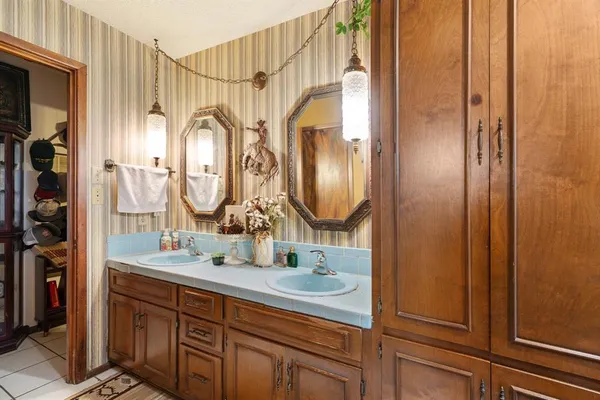 a bathroom with a double vanity sink and a mirror