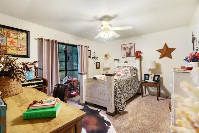 a bedroom with furniture and a large window
