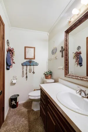 a bathroom with a sink a toilet and a mirror
