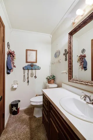 a bathroom with a sink a toilet and a mirror