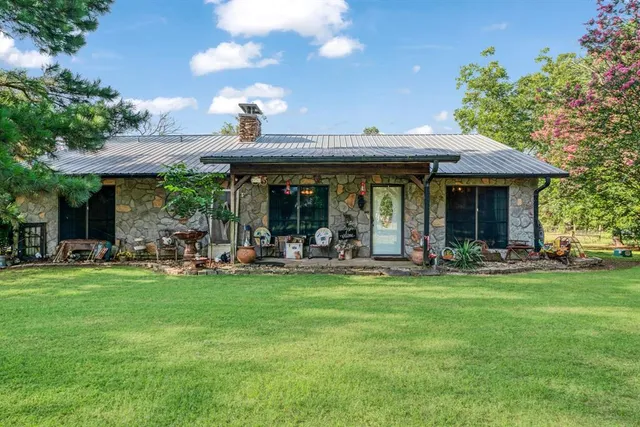 a view of a house with a yard porch and sitting area