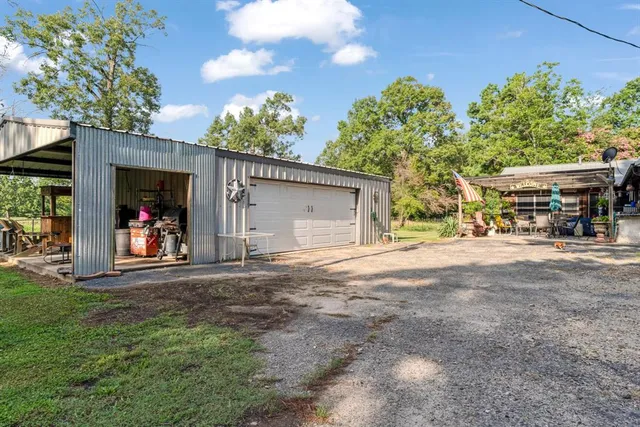 a view of a house with a yard and a garage