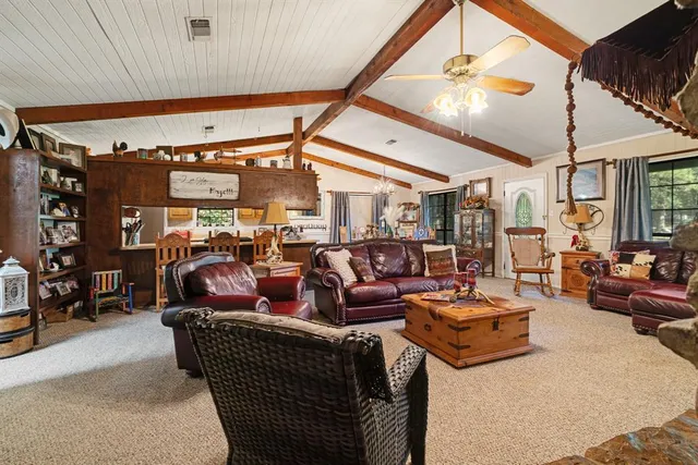 a living room with lots of furniture and lamp