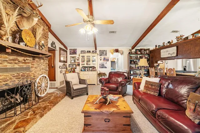 a living room with furniture and a floor to ceiling window