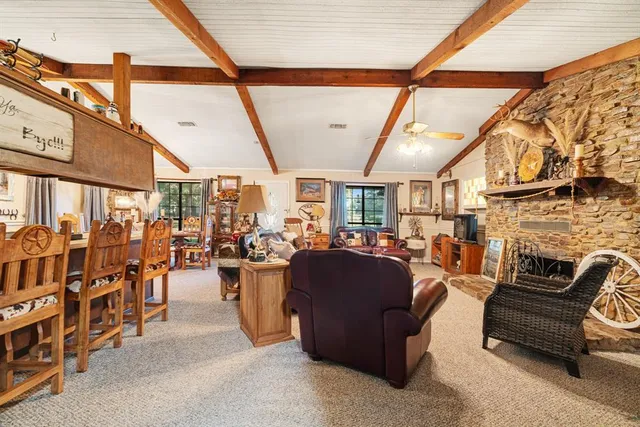 a living room with lots of furniture and fireplace