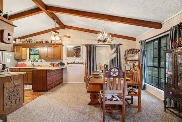 a view of a dining room with furniture and chandelier