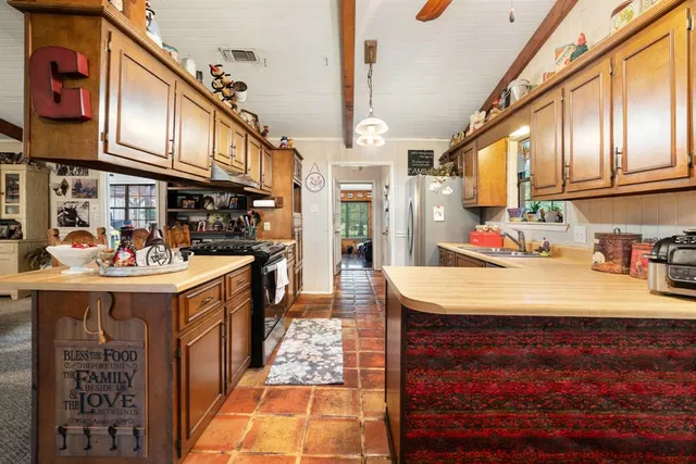 a view of a kitchen with furniture and cars