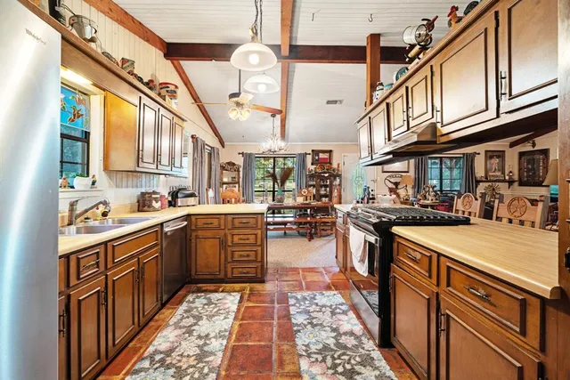 a kitchen with stainless steel appliances granite countertop a sink and cabinets