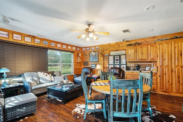 a living room with fireplace furniture and a large window