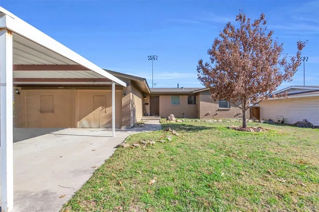 a view of a livingroom with wooden floor and a fireplace