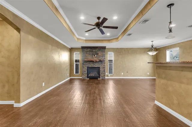 a front view of house with yard and trees in the background