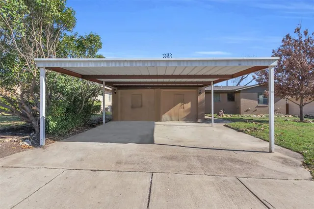 a view of a kitchen with a sink and a refrigerator