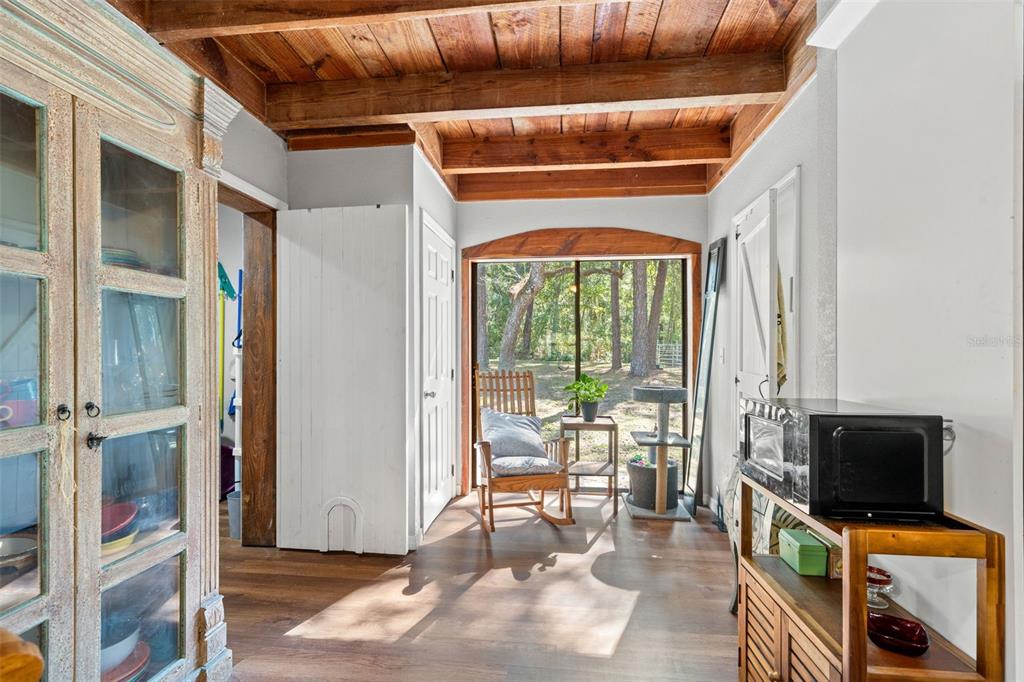 4292 Culbreath Road Brooksville, FL 34601 - Photo 18 of 41 a view of an empty room with wooden floor and a fireplace