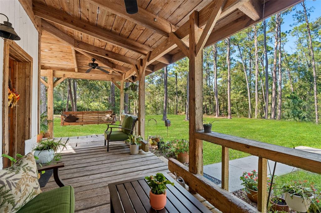 4292 Culbreath Road Brooksville, FL 34601 - Photo 30 of 41 a view of a patio with table and chairs potted plants and wooden floor
