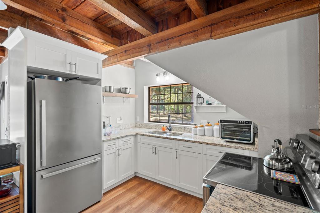 4292 Culbreath Road Brooksville, FL 34601 - Photo 4 of 41 a kitchen with a refrigerator and a sink