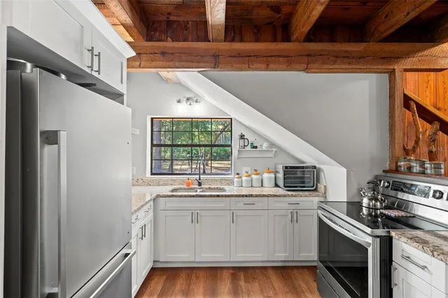a kitchen with a sink stove and cabinets
