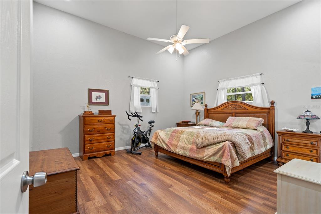 4292 Culbreath Road Brooksville, FL 34601 - Photo 10 of 41 a bedroom with a bed and a chandelier