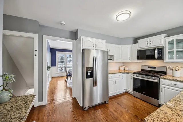 a kitchen with stainless steel appliances granite countertop a refrigerator stove and sink