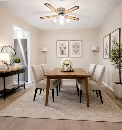 a view of a room with a window and a ceiling fan