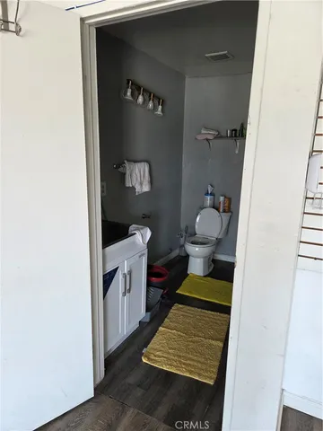 a bathroom with a toilet a sink and mirror