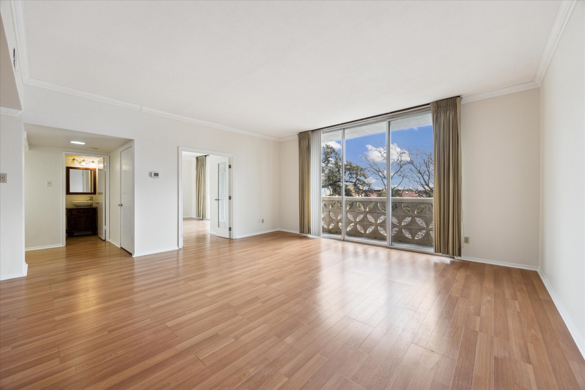 1801 Lavaca Street, Unit 2D Austin, TX 78701 - Photo 4 of 25 a view of an empty room with wooden floor and a window