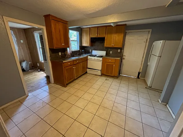 a bathroom with a tub sink and mirror