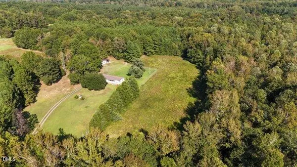 an aerial view of a houses with a yard