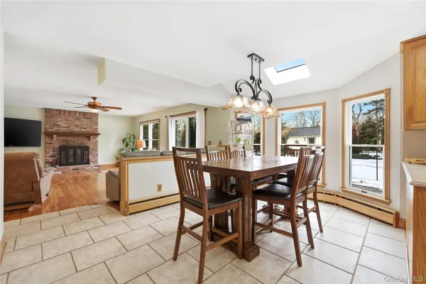 a view of a dining room with furniture and a chandelier