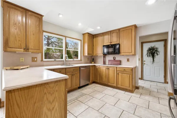 a kitchen with a sink window and cabinets
