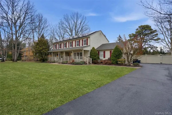 a front view of house with yard and green space