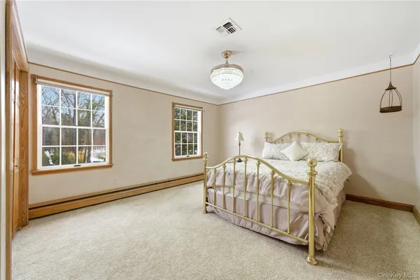 a bedroom with a bed and window