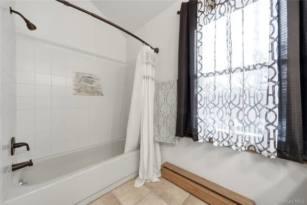 a bathroom with a bathtub and shower
