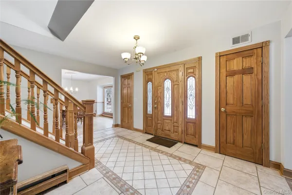 a view of a entryway door with chandelier and livingroom