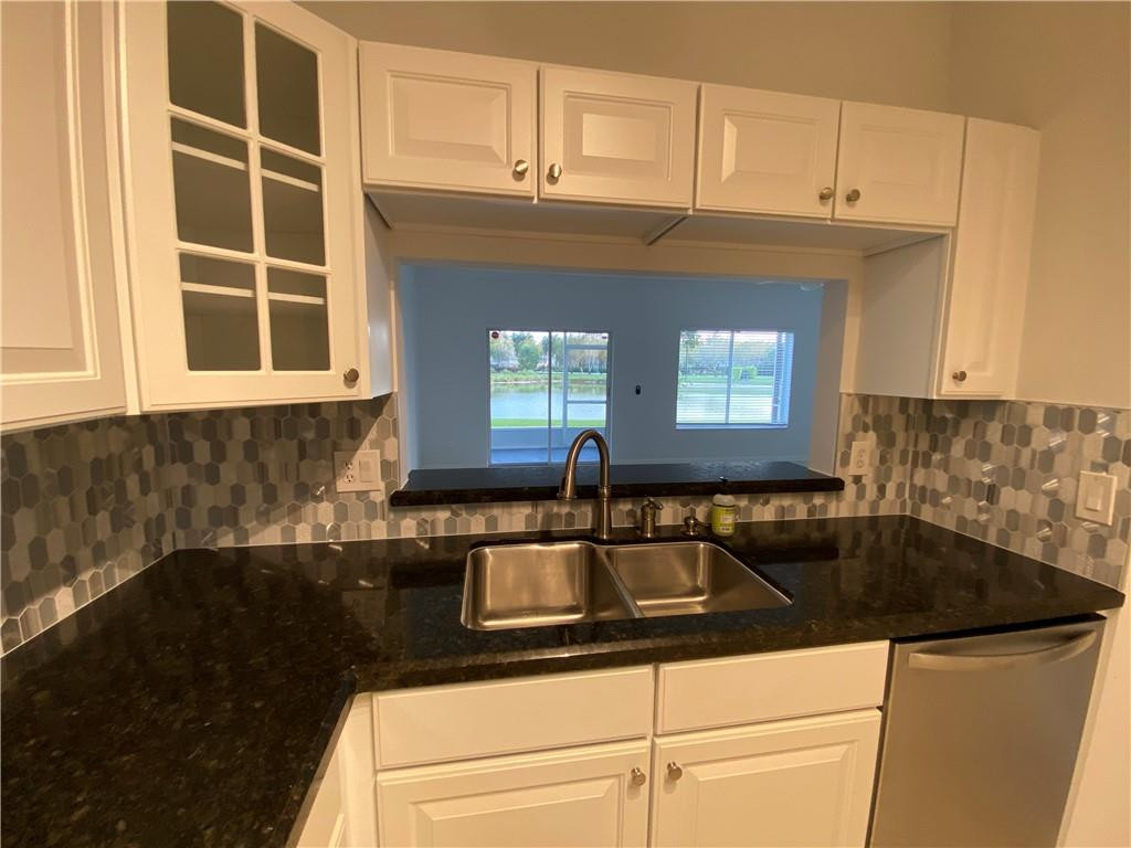 8304 Via Leonessa, Unit 8304 Boca Raton, FL 33433 - Photo 9 of 47 Pass through window in kitchen