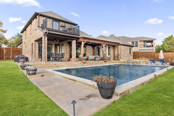 a view of a house with sitting area and swimming pool