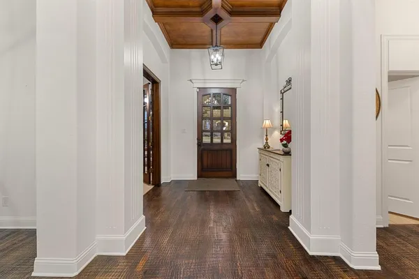 a view of an entryway with wooden floor