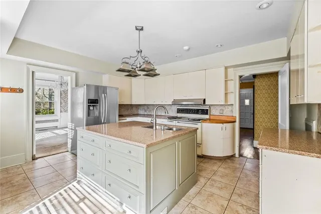 a kitchen that has a lot of cabinets a sink and a dishwasher